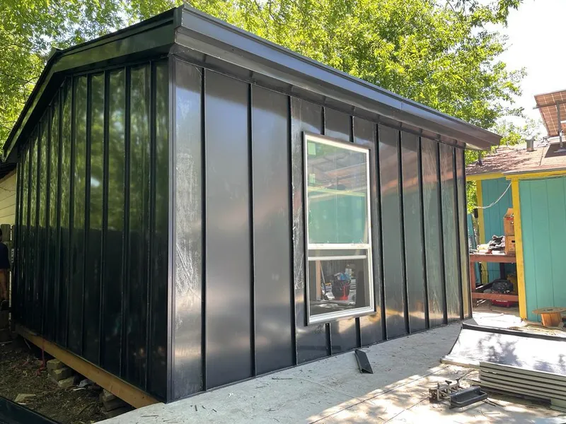 Black standing seam metal wall panels for Roof Inspection in Wells Branch