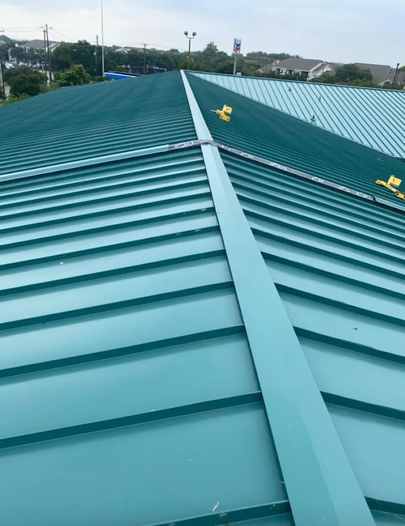 Green commercial metal roof ridge and valley for Metal Roof Repair in Wells Branch